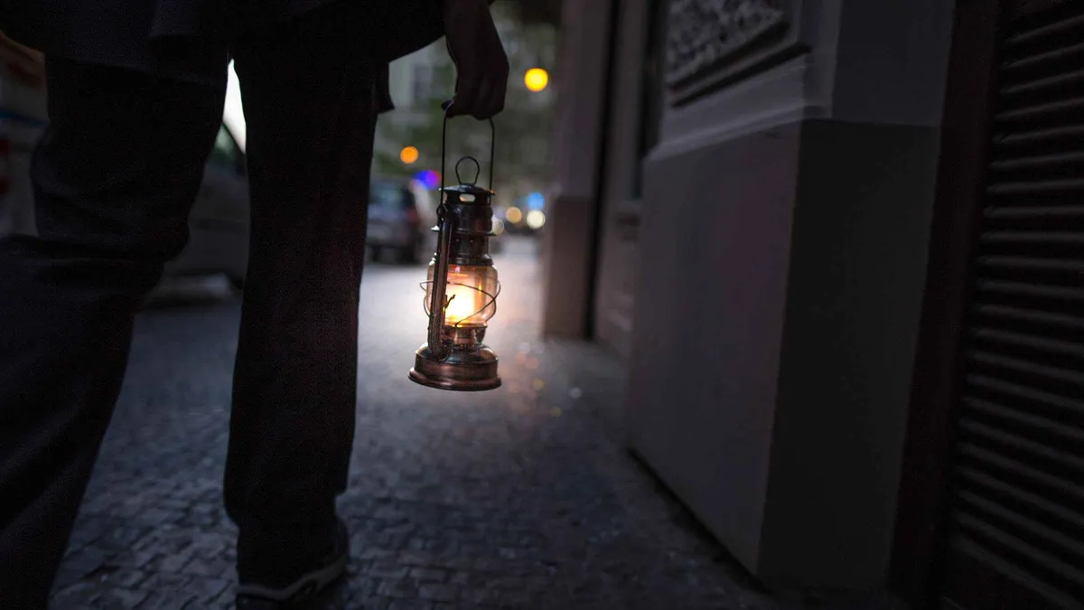 Guide leading a small group on a Prague Old Town ghost tour at night, Czechia