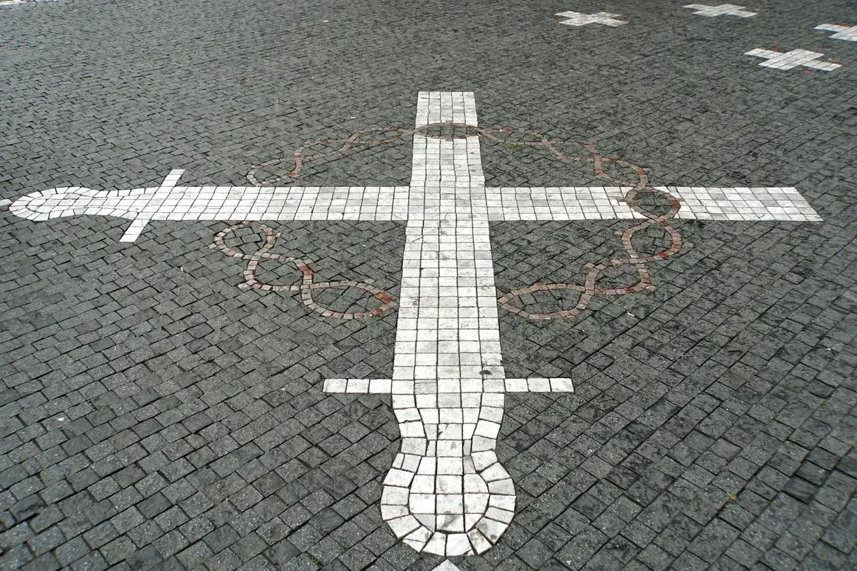The white crosses in the Old Town Square pavement for the 1621 executions, told on every ghost tour in Prague